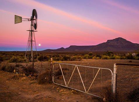 What does addressing the land question in South Africa actually involve?